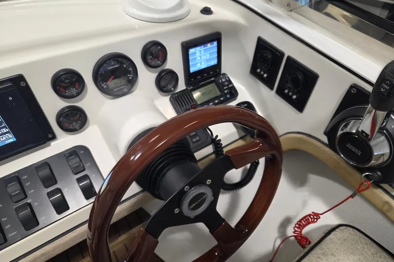 Slide: The Image of Dashboard of a 2010 Westport 23 Bow Rider Tender with gauges and controls. - 5