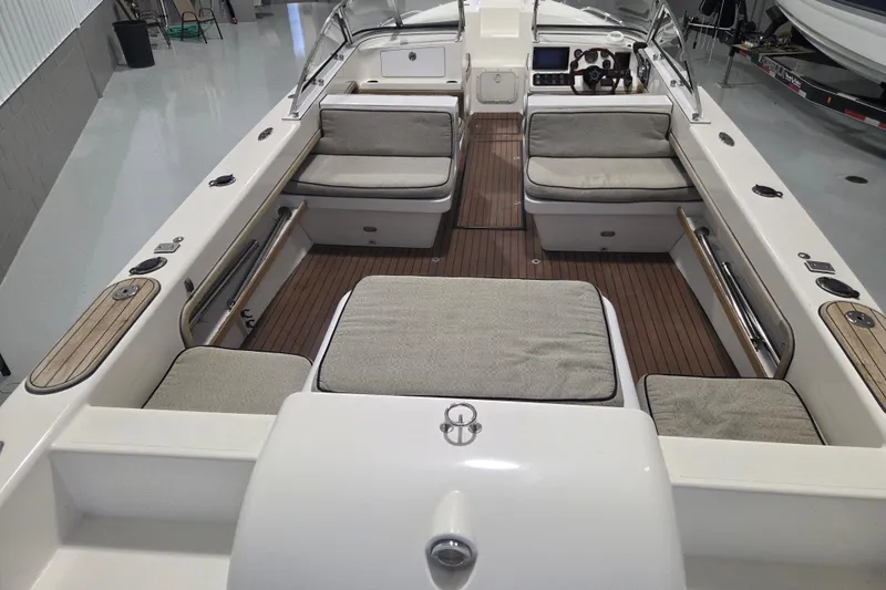 Slide: The Image of 2010 Westport 23 Bow Rider Tender with cushioned seating and sleek interior design. - 6