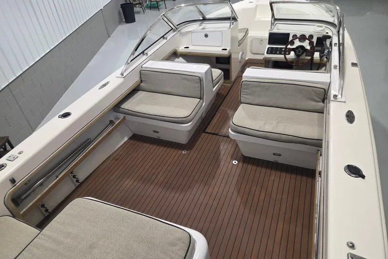 Slide: The Image of 2010 Westport 23 Bow Rider Tender with spacious seating and elegant wood flooring. - 7