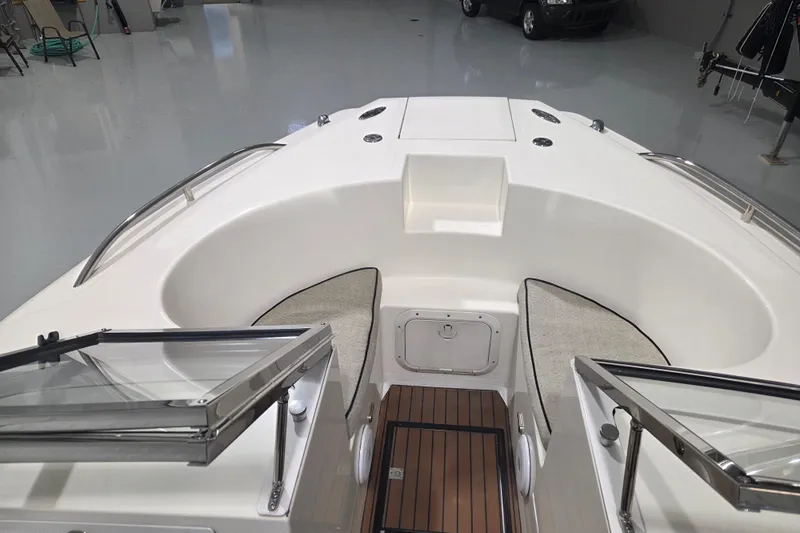 Slide: The Image of 2010 Westport 23 Bow Rider Tender interior with cushioned seating and sleek design. - 8