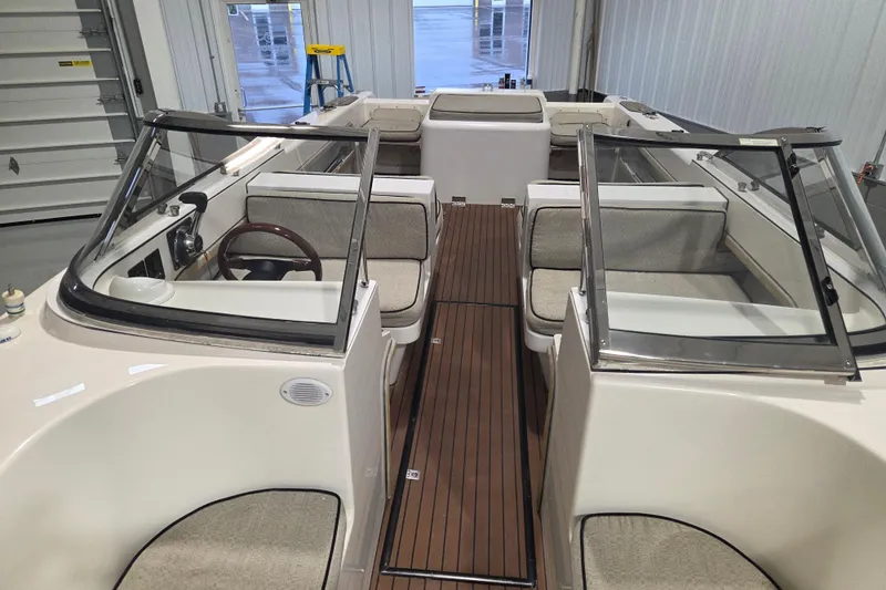 Slide: The Image of 2010 Westport 23 Bow Rider Tender with spacious seating and sleek design in a garage setting. - 9