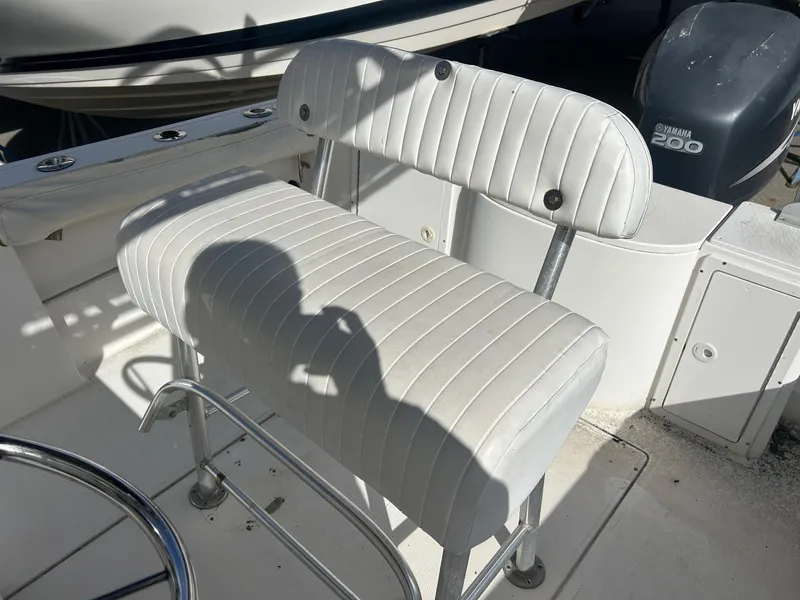 Slide: The Image of White cushioned seat on 1998 Cobia 224 CC boat with Yamaha 200 engine. - 10