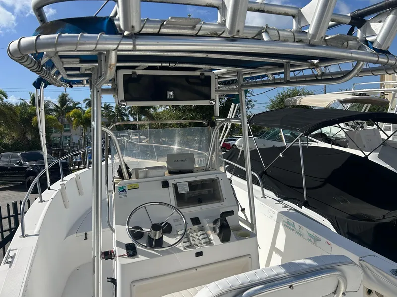Slide: The Image of 1998 Cobia 224 CC boat interior with steering wheel and navigation equipment. - 2