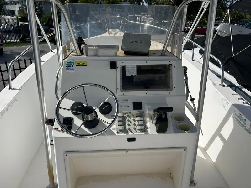 Slide: The Image of 1998 Cobia 224 CC boat console with steering wheel and Garmin device. - 3