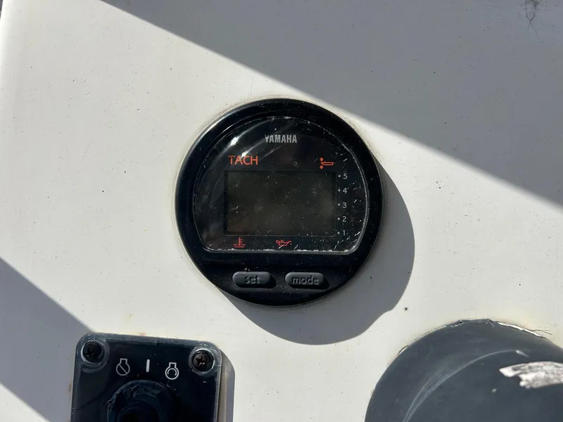 Slide: The Image of Yamaha tachometer on 1998 Cobia 224 CC boat dashboard. - 7