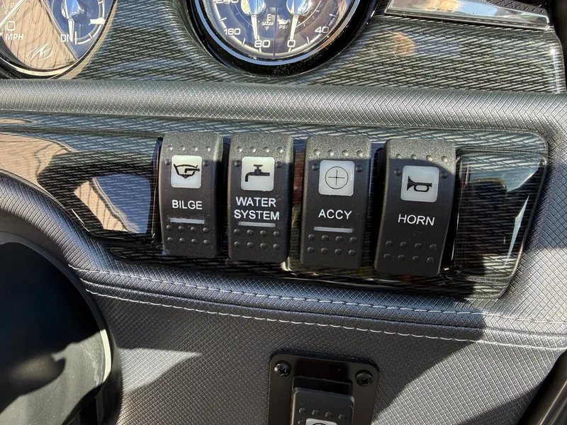 Slide: The Image of 2023 Monterey 224FS dashboard with bilge, water system, accessory, and horn switches. - 16