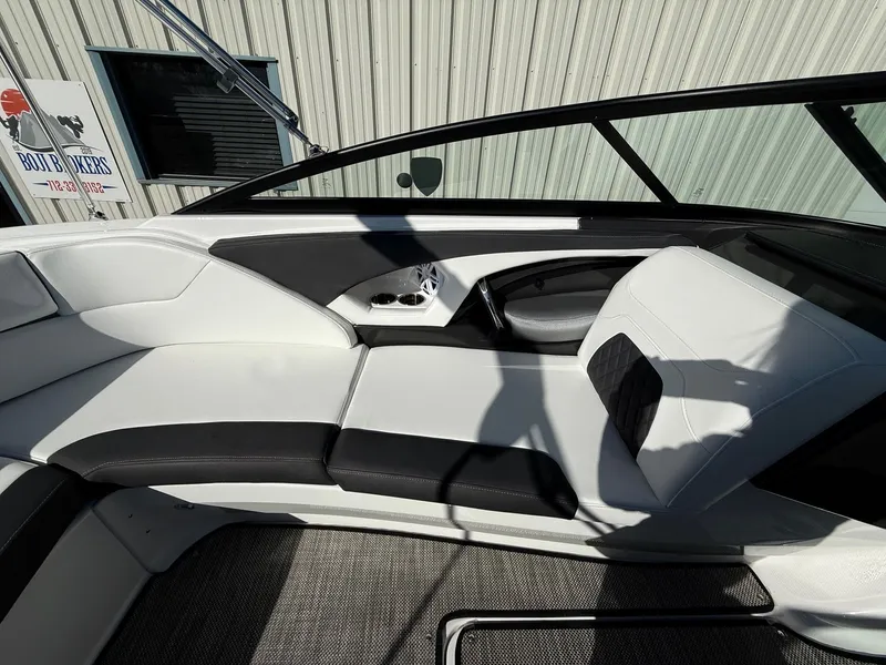 Slide: The Image of Interior of a 2023 Monterey 224FS boat with white and black seating. - 21