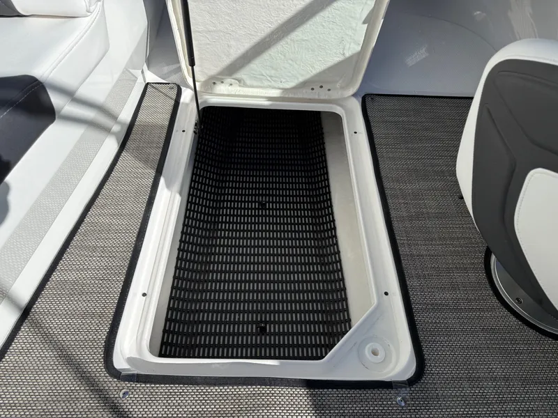 Slide: The Image of Interior of 2023 Monterey 224FS boat with open storage compartment. - 23