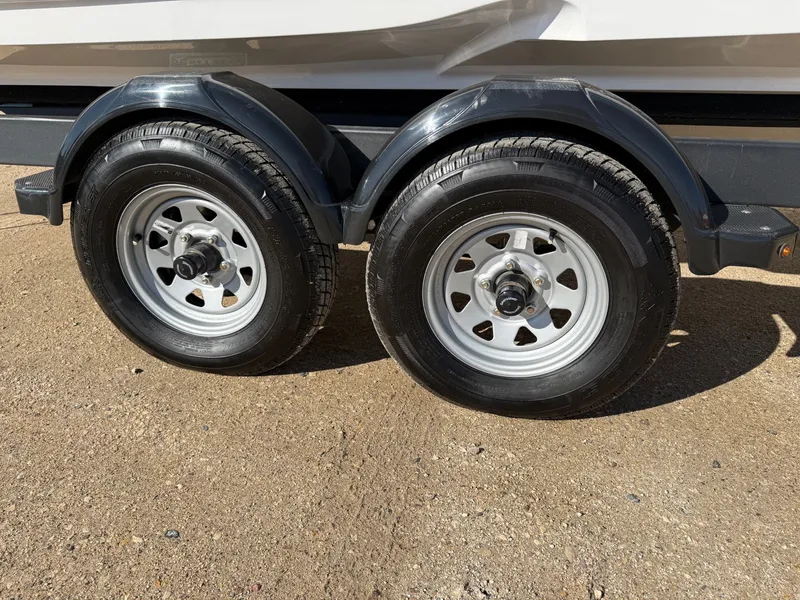 Slide: The Image of Dual trailer wheels of a 2023 Monterey 224FS boat trailer. - 31