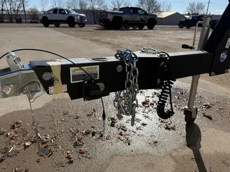 Slide: The Image of Trailer hitch of a 2023 Monterey 224FS boat trailer on parking lot. - 32