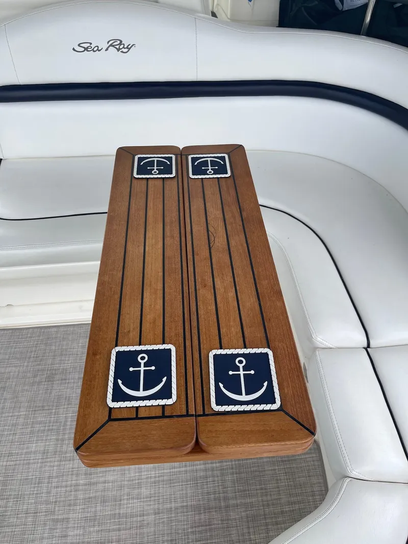 Slide: The Image of Interior of 2007 Sea Ray 380 Sundancer with wooden table and anchor design. - 17