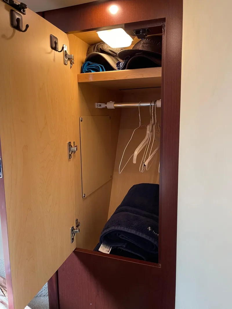 Slide: The Image of Closet in 2007 Sea Ray 380 Sundancer with clothes and hangers. - 21