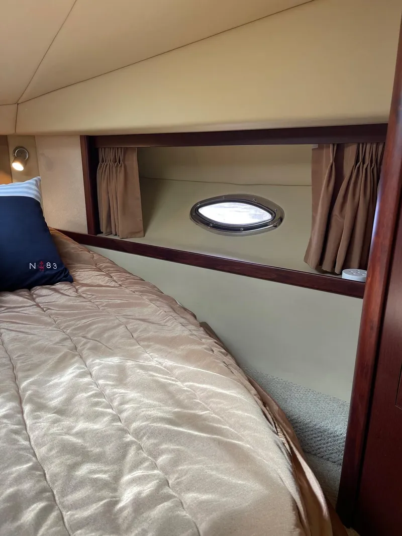 Slide: The Image of Interior of 2007 Sea Ray 380 Sundancer with bed and porthole. - 24