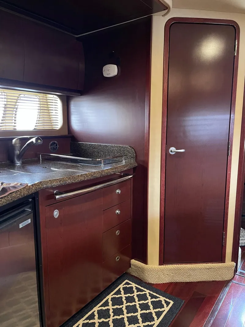 Slide: The Image of 2007 Sea Ray 380 Sundancer kitchen interior with wood finish. - 32