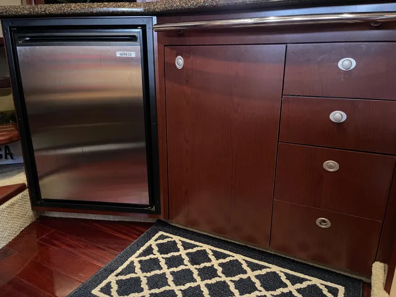 Slide: The Image of Sea Ray 380 Sundancer 2007 kitchen area with fridge and cabinets. - 42