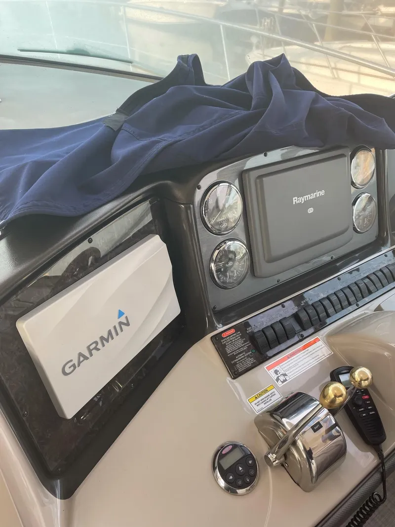 Slide: The Image of Sea Ray 380 Sundancer 2007 dashboard with Garmin and Raymarine equipment. - 7