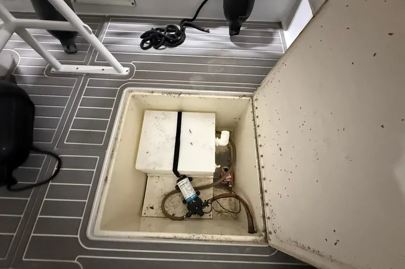 Slide: The Image of 1988 Stamas 255 Tarpon boat compartment with storage and equipment. - 10