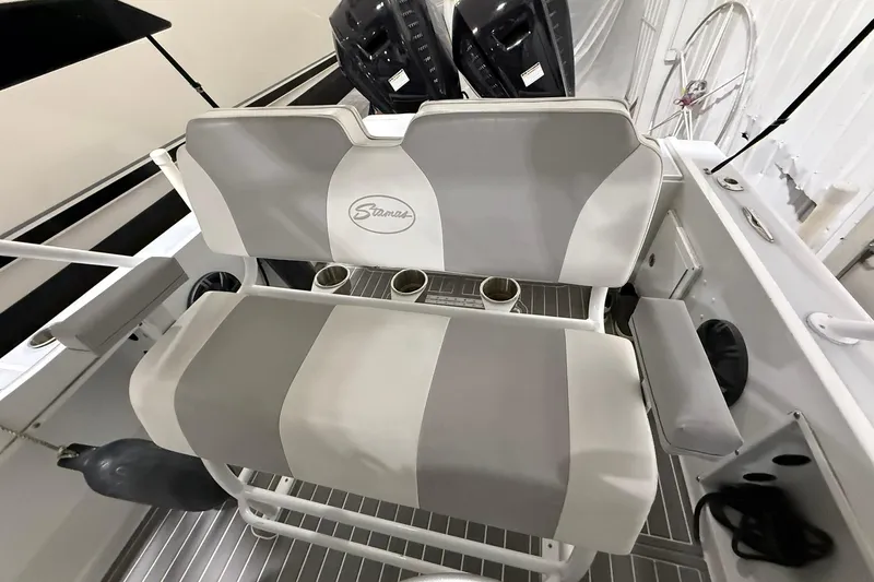 Slide: The Image of 1988 Stamas 255 Tarpon boat seating with cup holders and sleek design. - 13