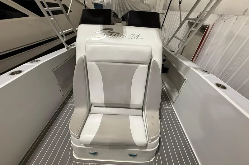 Slide: The Image of 1988 Stamas 255 Tarpon boat interior with white seating and sleek design. - 14
