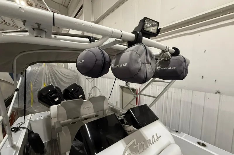 Slide: The Image of 1988 Stamas 255 Tarpon boat interior with Rockville speakers and dual engines. - 17