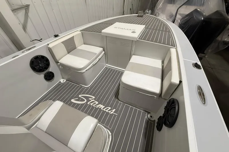 Slide: The Image of 1988 Stamas 255 Tarpon boat interior with cushioned seating and branded flooring. - 18
