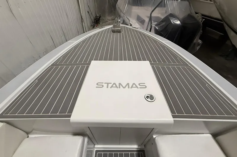 Slide: The Image of 1988 Stamas 255 Tarpon boat deck with logo, in storage facility. - 19
