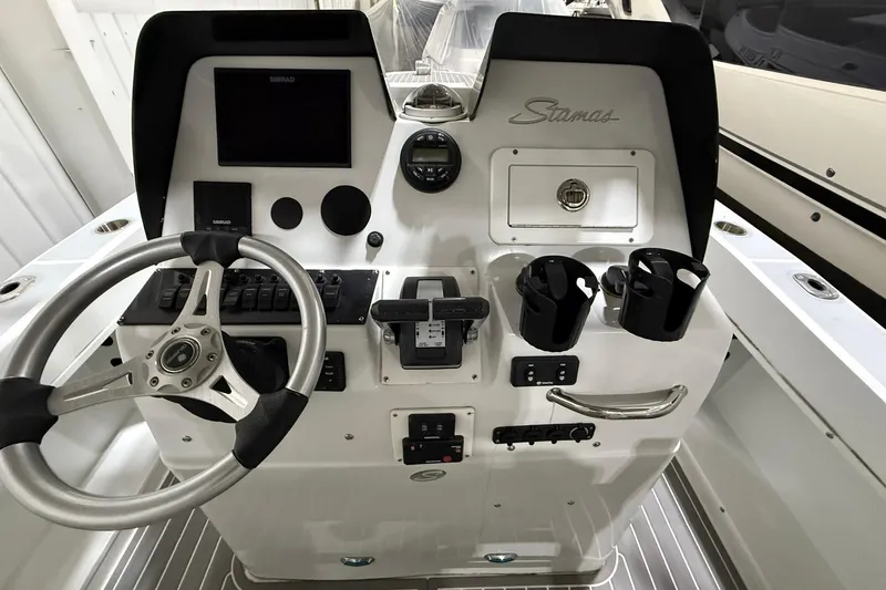 Slide: The Image of 1988 Stamas 255 Tarpon boat dashboard with steering wheel and control panel. - 22