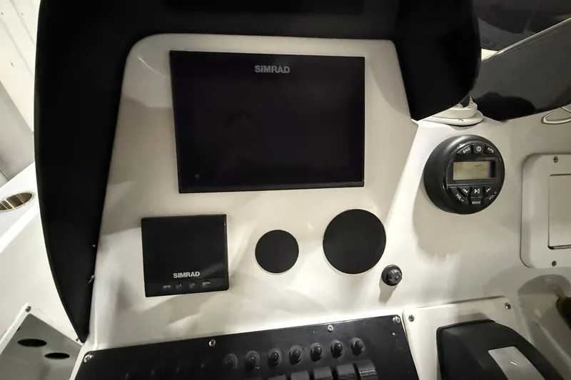 Slide: The Image of Dashboard of a 1988 Stamas 255 Tarpon boat with Simrad electronics. - 23