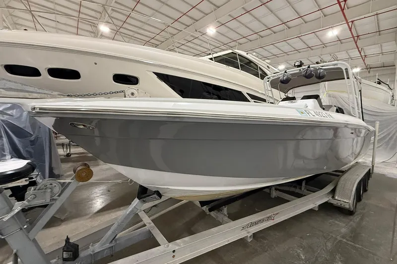 Slide: The Image of 1988 Stamas 255 Tarpon boat on trailer in indoor storage facility. - 3