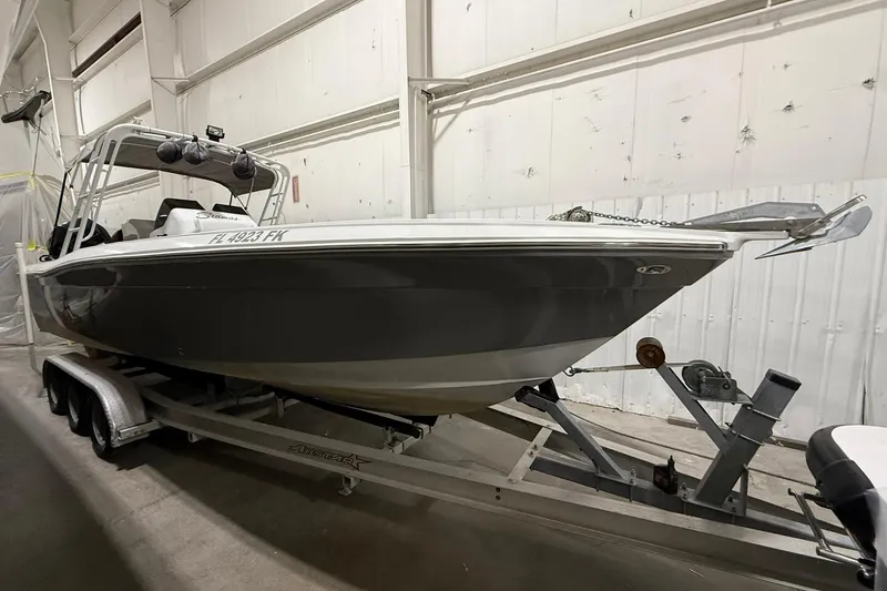 Slide: The Image of 1988 Stamas 255 Tarpon boat on trailer in indoor storage facility. - 4