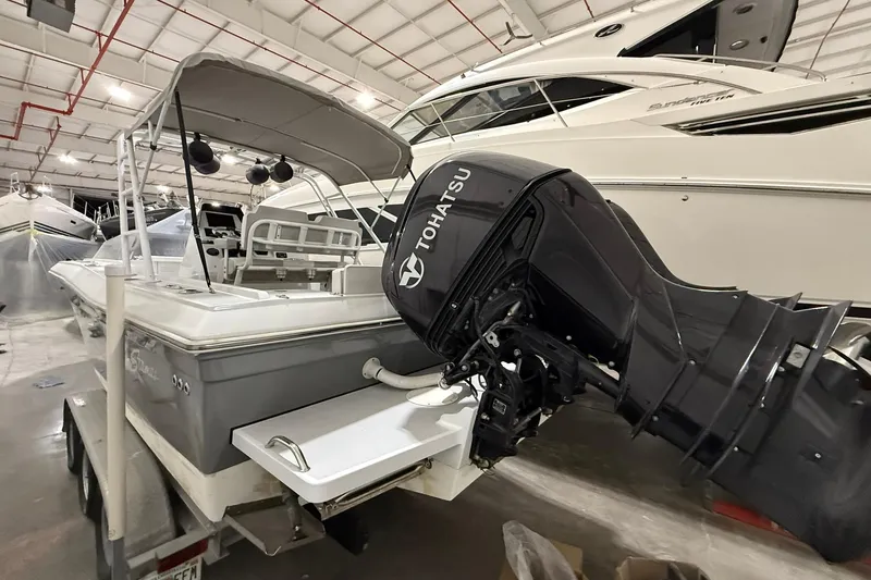 Slide: The Image of 1988 Stamas 255 Tarpon boat with Tohatsu outboard motor in indoor storage. - 6