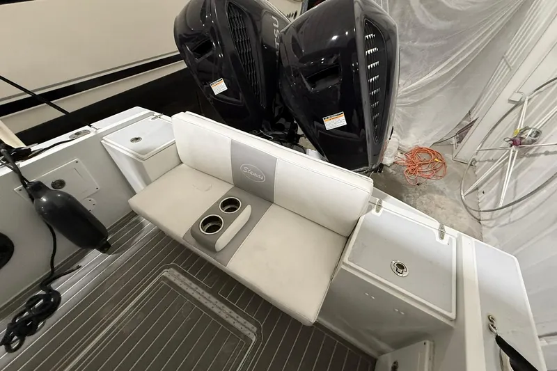 Slide: The Image of 1988 Stamas 255 Tarpon boat interior with seating and dual outboard motors. - 7