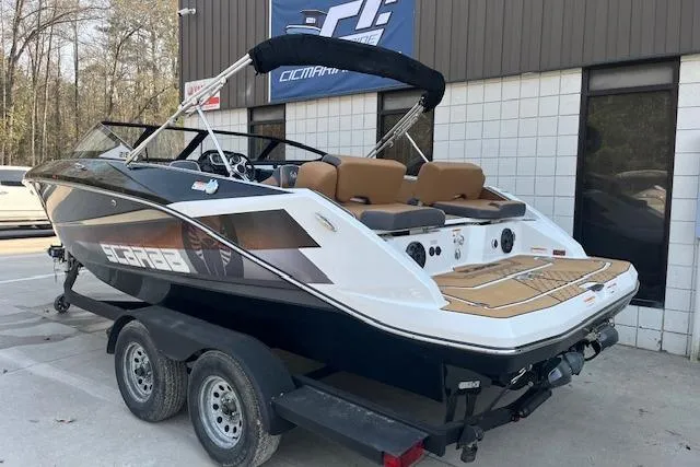 Slide: The Image of 2021 Scarab 215 ID boat on trailer, parked outside a building. - 20