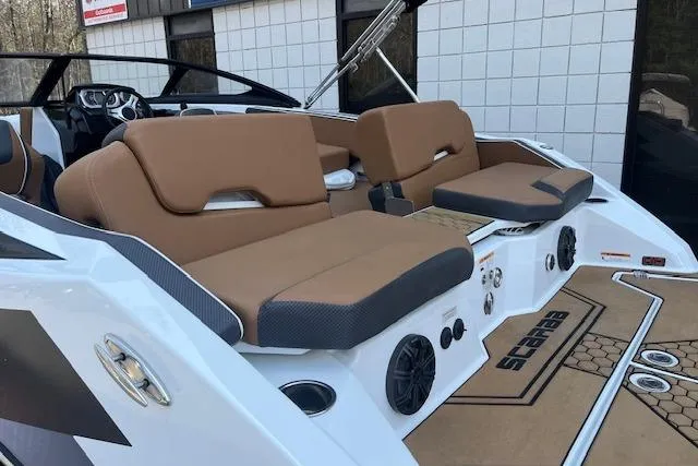Slide: The Image of 2021 Scarab 215 ID boat interior with tan seating and modern dashboard design. - 24