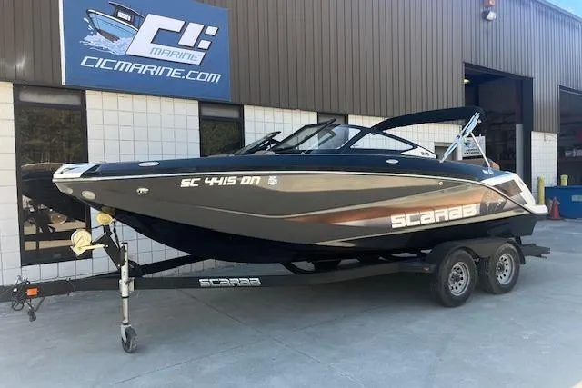 Slide: The Image of 2021 Scarab 215 ID boat on trailer outside CIC Marine building. - 25