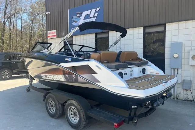 Slide: The Image of 2021 Scarab 215 ID boat on trailer, parked outside a building. - 27