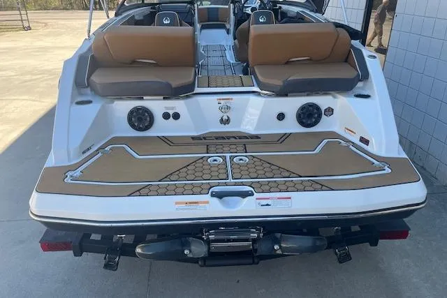 Slide: The Image of 2021 Scarab 215 ID boat, rear view with seating and speakers, parked outdoors. - 28