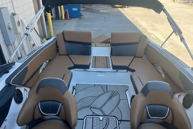 Slide: The Image of 2021 Scarab 215 ID boat interior with tan and black seating, stylish design. - 30