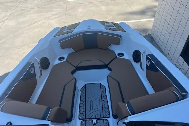 Slide: The Image of 2021 Scarab 215 ID boat interior with brown seating and modern design. - 31