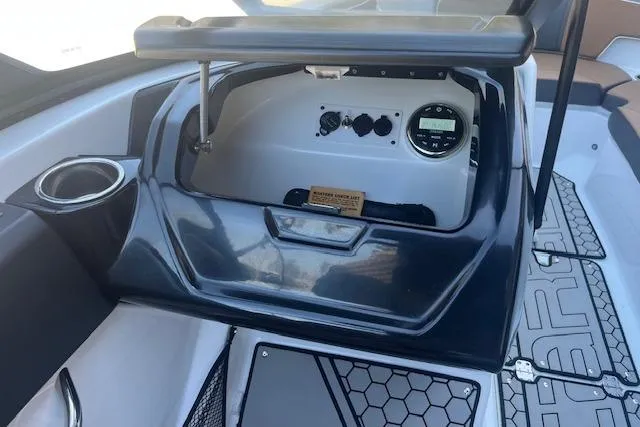 Slide: The Image of 2021 Scarab 215 ID boat dashboard with controls and cup holder. - 32