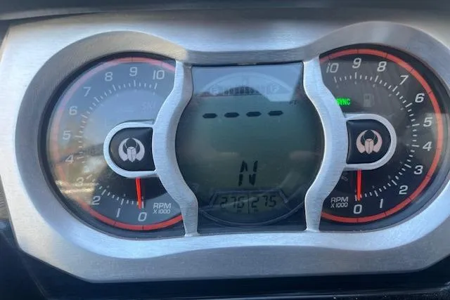 Slide: The Image of Dashboard of a 2021 Scarab 215 ID boat showing RPM gauges and digital display. - 33