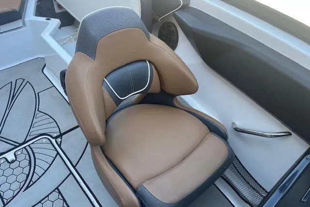 Slide: The Image of 2021 Scarab 215 ID boat interior with brown and black cushioned seat. - 35