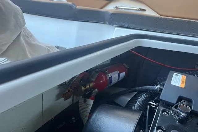 Slide: The Image of Interior view of a 2021 Scarab 215 ID boat showing engine compartment and fire extinguisher. - 41