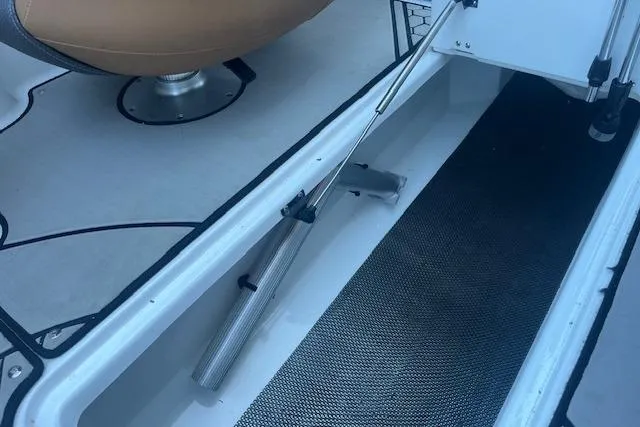 Slide: The Image of Interior view of a 2021 Scarab 215 ID boat, featuring storage compartment and seating. - 44