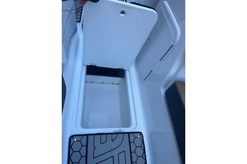 Slide: The Image of 2021 Scarab 215 ID boat storage compartment with open hatch. - 47