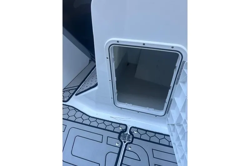 Slide: The Image of 2021 Scarab 215 ID boat storage compartment with open hatch and patterned flooring. - 48