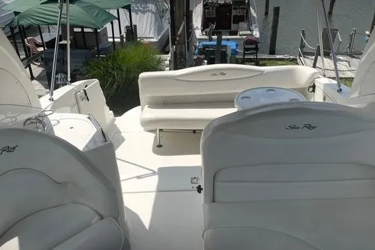 Slide: The Image of 2004 Sea Ray Sundancer 280 boat interior with white seating and deck area. - 12