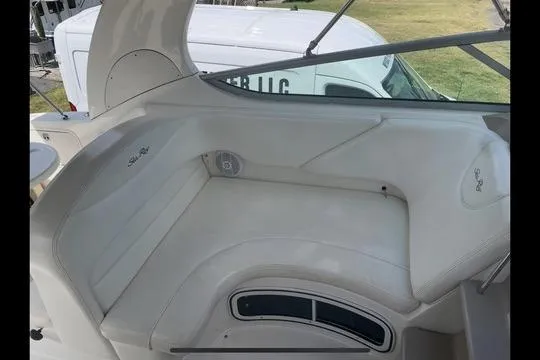 Slide: The Image of 2004 Sea Ray Sundancer 280 boat interior with white seating and sleek design. - 13