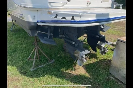 Slide: The Image of 2004 Sea Ray Sundancer 280 boat on stands, showing dual propellers and stern drive. - 3