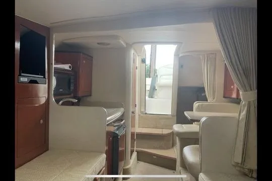 Slide: The Image of Interior of 2004 Sea Ray Sundancer 280 yacht, featuring kitchen and seating area. - 5